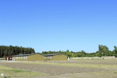 Oranienburg, Germany - July 1 2015: Former WWII Barracks at Sachsenhausen Concentration Camp Memorial under Clear Blue Sky. High quality photo clipart