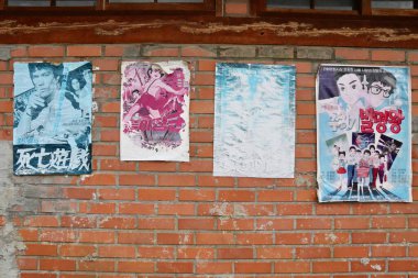 Seoul, South Korea - September 11 2019: Vintage Korean Movie and Animation Posters Featuring Bruce Lee on Old Brick Wall in the National Folk Museum of Korea. High quality photo clipart