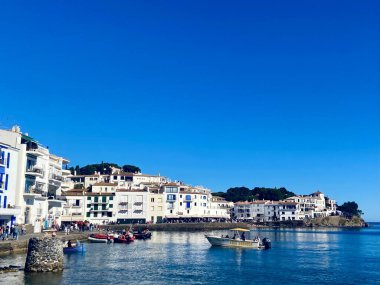 Cadaques, Spain - April 8 2023: Picturesque Coastal Town with Whitewashed Buildings, Boats, and a Vibrant Blue Sky. High quality photo clipart