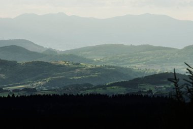 view at sunny day on the foggy volcano mountains of the French region of the Auvergne in summer