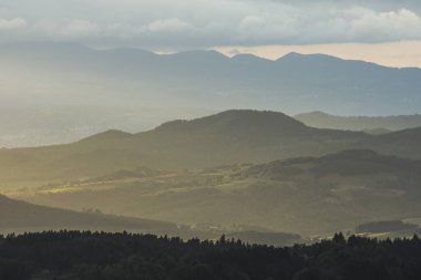 artistic view on the volcano mountains in summer of nature area of the Auvergne at sunset