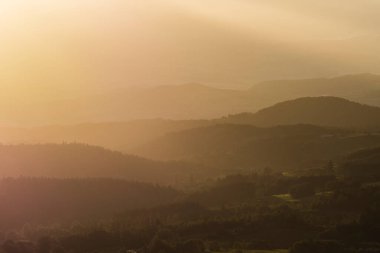 artistic view on the volcano mountains in summer of nature area of the Auvergne at sunset