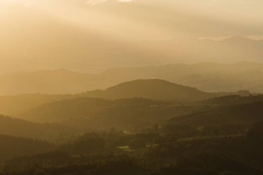 artistic view on the volcano mountains in summer of nature area of the Auvergne at sunset
