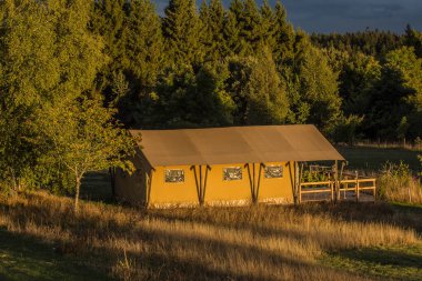 tent on a camping site in the mountains of the Auvergne at sunset in summer