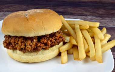 sloppy joe  with fries on a plate clipart