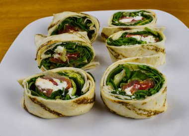 spinach and feta pinwheel sandwich on a plate clipart