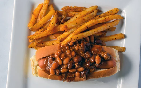 chili dog served with a side of fries