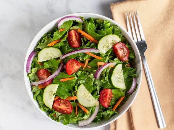 stock image garden salad with onions, tomatoes,  and carrots