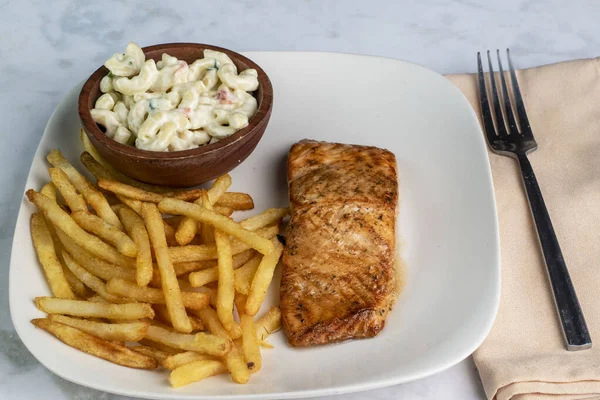 stock image bourbon salmon  served with  french fries and macaroni sald, 