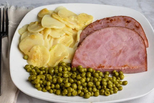 Scalloped Potatoes Served Ham Peas Stock Picture