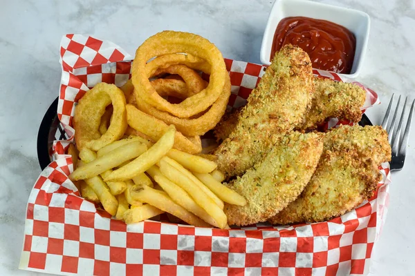 crispy chicken fingers served with french fries and onion rings