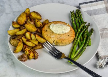Somon burger üstü, patates püresi ve sotelenmiş kuşkonmaz.,