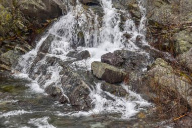water cascading over  rocks at the spillway of the quabbin reservoir clipart