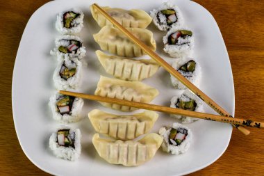 chicken dumblings served  california roll clipart