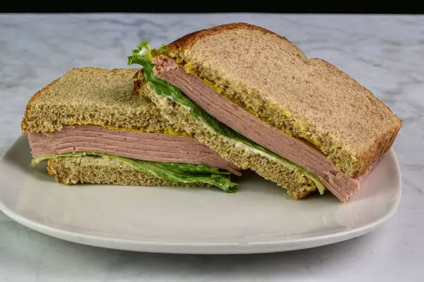 Buğday ekmeğine hardallı salamlı sandviç.