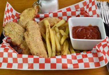 Kızarmış tavukla servis edilen parmak tavuk sepeti.