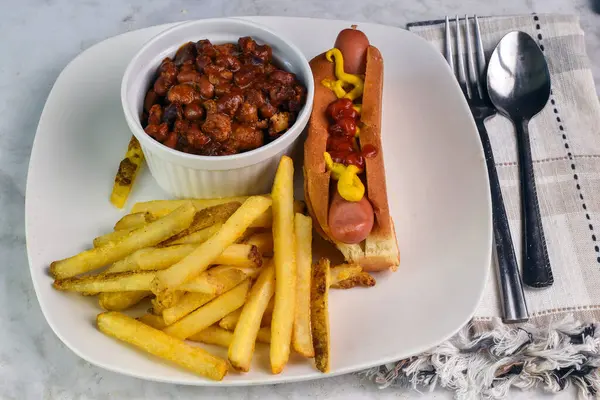 stock image hot dog top with mustard and ketchup  served with chilli and fries,