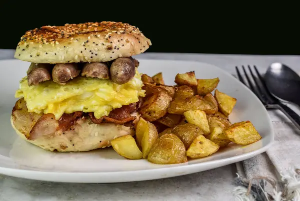 stock image scramble egg  with bacon and sausage on  a everything bagel,