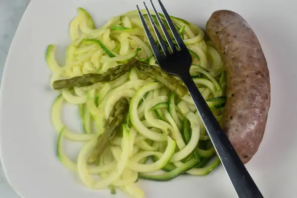 stock image zucchini and asparagus served with sweet italian sausage