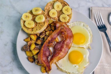 Patates kızartması ve domuz pastırmalı patates kızartması. Yanında da İngiliz keki, fıstık ezmesi ve muz.