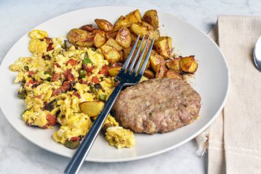 Sotelenmiş onnion ve biberli omlet sosisli börek ve patates kızartması.