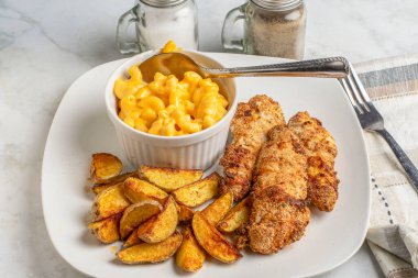 chicken  fingers served with mac and cheese and potato wedges, clipart