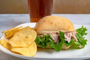 tuna  with lettuce on a ciabatta roll with chips clipart