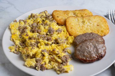 Hamburg usulü omlet ve yanında sosisli börek ve patates kızartması.