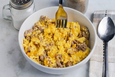 Çırpılmış yumurta ve sosis kasede.