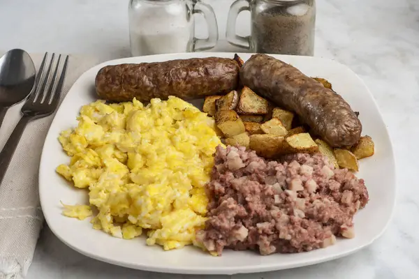 Çırpılmış yumurta, tatlı İtalyan sosisi, yanında mısır gevreği ve patates kızartması..