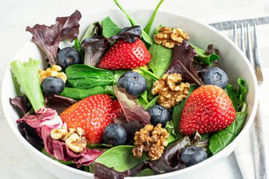 Bahar salatası ve çilek ve yaban mersini üstü ve ceviz.