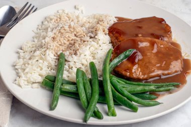 Soğan soslu salisbury bifteği ve patates püresiyle servis edilen mantarlar.