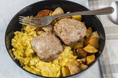 Patates kızartması ve sosisli börekle servis edilmiş omlet.
