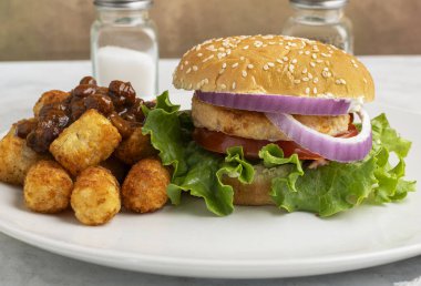 Salatalı somon burger, domates ve soğanlı biberli patates kroket..