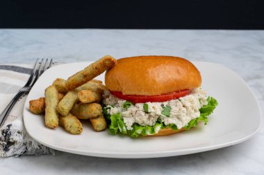  Yeşil soğanlı tavuklu sandviç. Brokoli kızartmasıyla servis edilen marul ve domates.