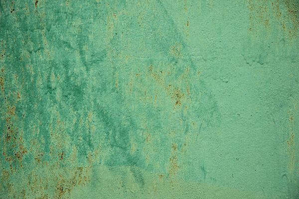 Aged green weathered textured background with brush strocks or grunge rough surface backdrop.