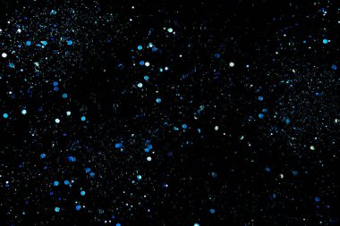 Siyah kozmik soyut arka planda mavi parıltılar ya da parıltılar. Mutlu Noeller bayram geçmişi.