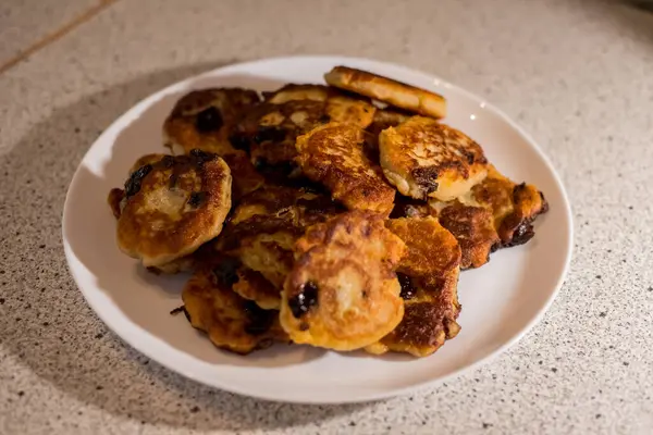 Beyaz tabakta servis edilen kirazlı süzme peynirli krepler. Altın hamuru, canlı böğürtlenlerin zıttıdır. Sunum lezzetli ve taze görünümün altını çiziyor. Ağız sulandırıcı görüntü tatmaya davet eder.