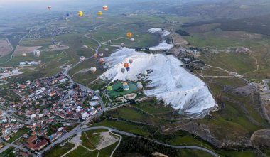 Pamukkale 'de güneş doğarken sıcak hava balonları ve doğal travertin havuzları, 