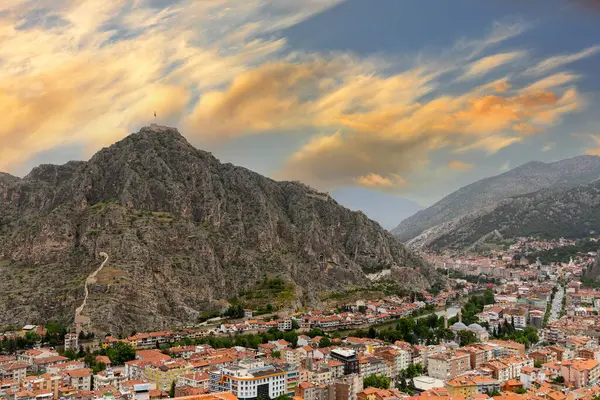 stock image Fascinating view of the city of Amasya, also known as the city of princes. wonderful clouds coming out of the mountains. YESILIRMAK river.