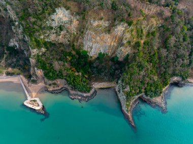 Lava columns formed 80 million years ago as a result of the cooling and crystallization of lava flowing from volcanoes on the Gzelcehisar coast of Bartn. clipart