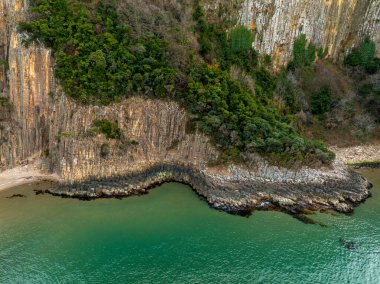 Lava columns formed 80 million years ago as a result of the cooling and crystallization of lava flowing from volcanoes on the Gzelcehisar coast of Bartn. clipart