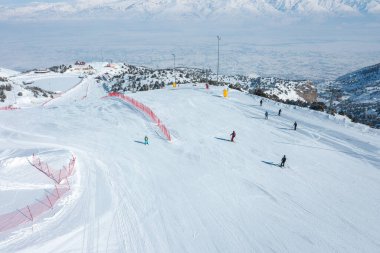 A view of skiers from Ergan ski resort, located among the mountains in Erzincan Province. clipart