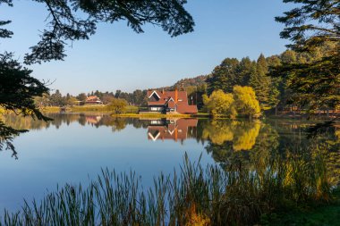 Bolu Golcuk Lake and famous house view with reflections. clipart