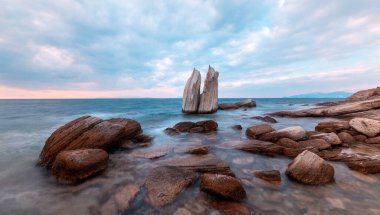 Long exposure photograph in the field of sail rocks in Foca district of Izmir province. clipart