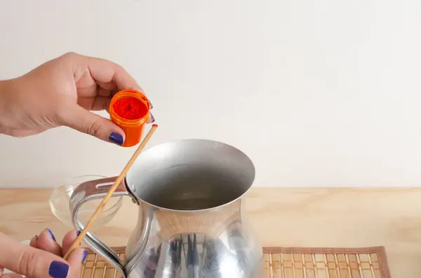 stock image Woman adding color pigment to soy vegetable wax mix to make organic, sustainable, vegan candles. Small businesses, female businesses.