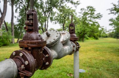 Industrial installation for potable water line feeding a private line with backflow, double block and meter clipart