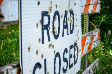 Buckshot road closed sign in front of a washed out bridge. High quality photo
