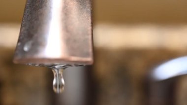 Sızdıran bir musluğun yavaş çekim makro videosu ve sürekli sızıntı. Yüksek kalite Tam HD görüntü