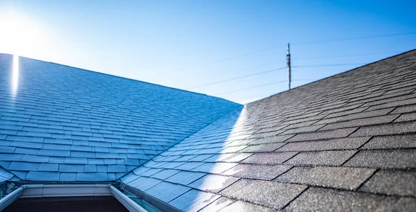 stock image distinct line of frost on a shingle roof as the sun hits the ridge in the morning